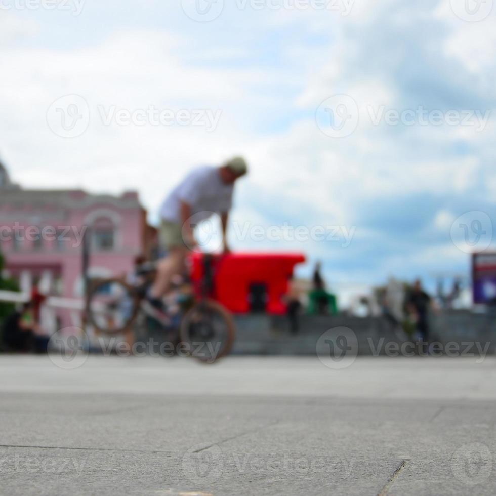 Defocused image of a lot of people with bmx bikes. Meeting of fans of extreme sports photo