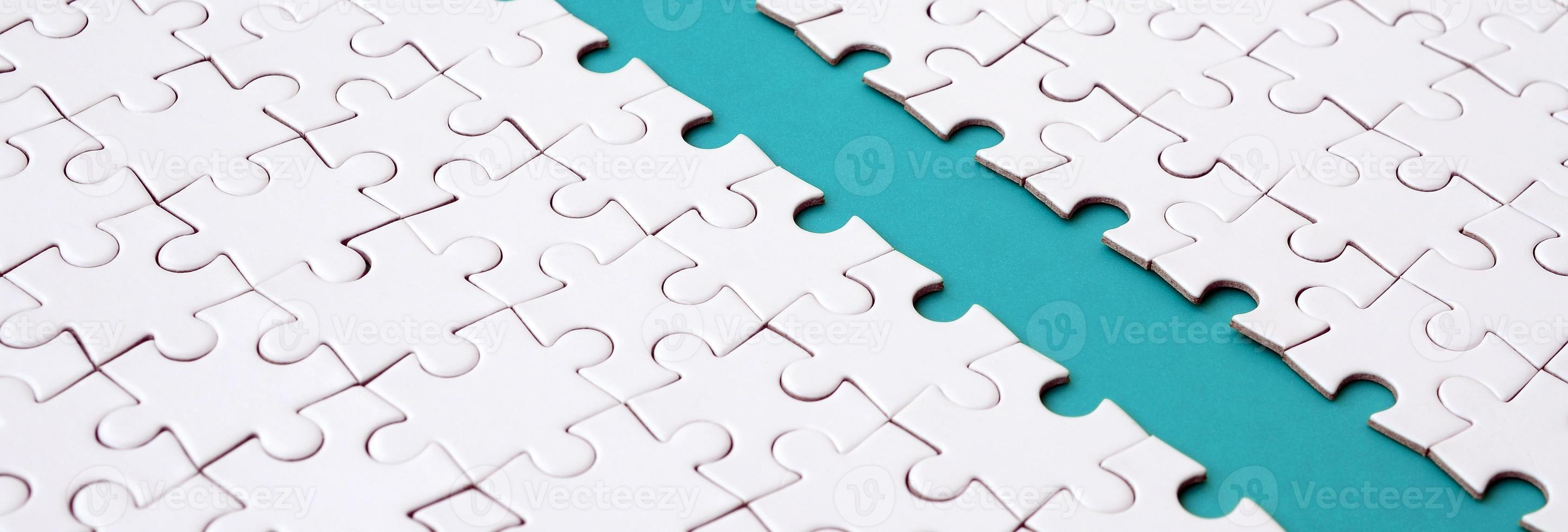 The blue path is laid on the platform of a white folded jigsaw puzzle. Texture image with copy space for text photo