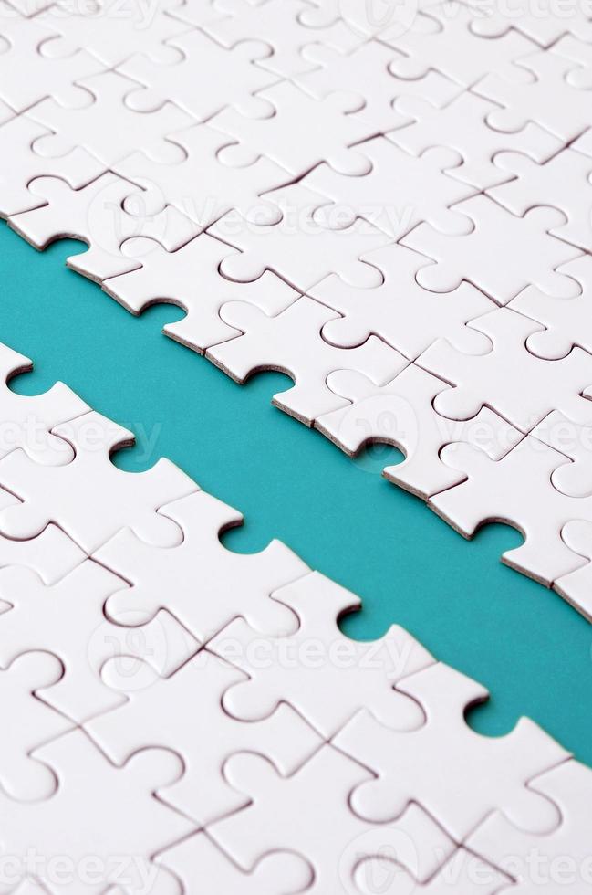 The blue path is laid on the platform of a white folded jigsaw puzzle. Texture image with copy space for text photo