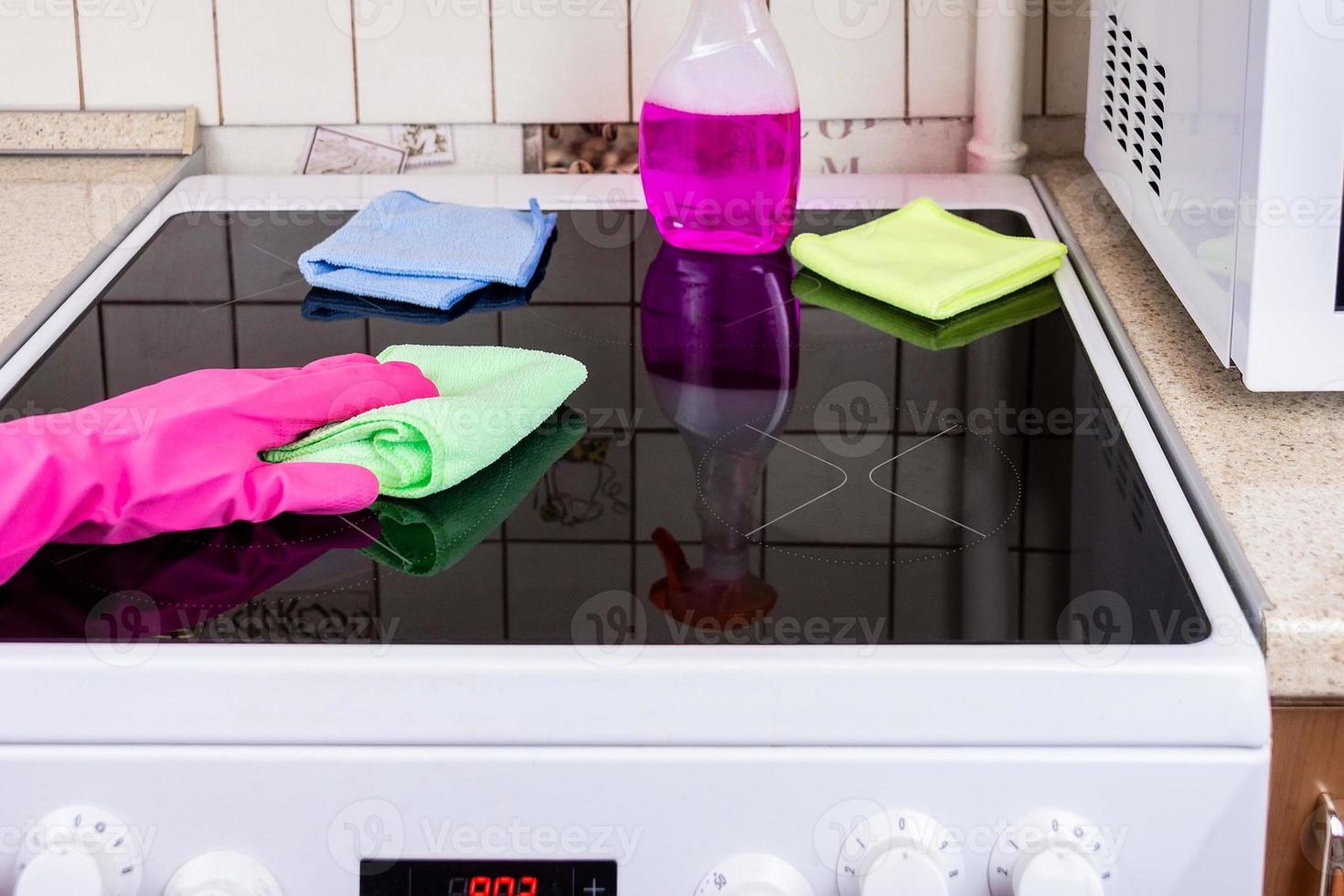 Cleaning the stove in the kitchen photo