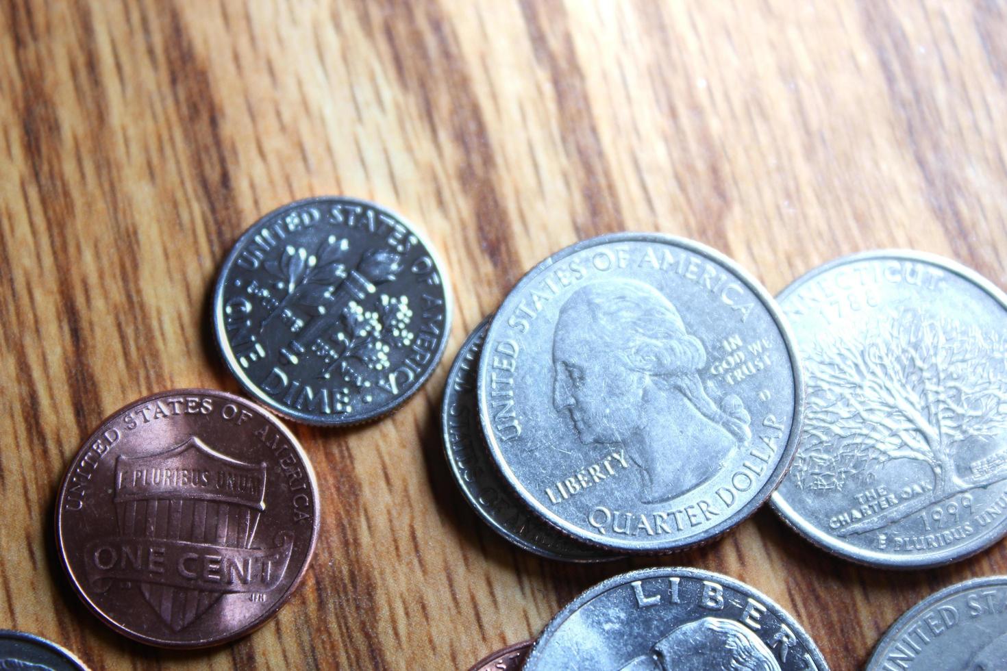 Dollar coins and dollar bills scattered on a wooden table, flat lay dollar coins. photo