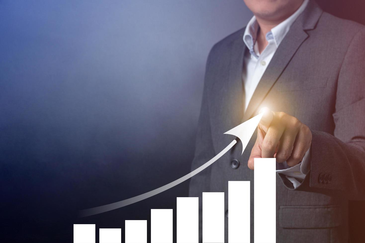 Double exposure of close up businessman touching on growth up chart with balck and gray background photo