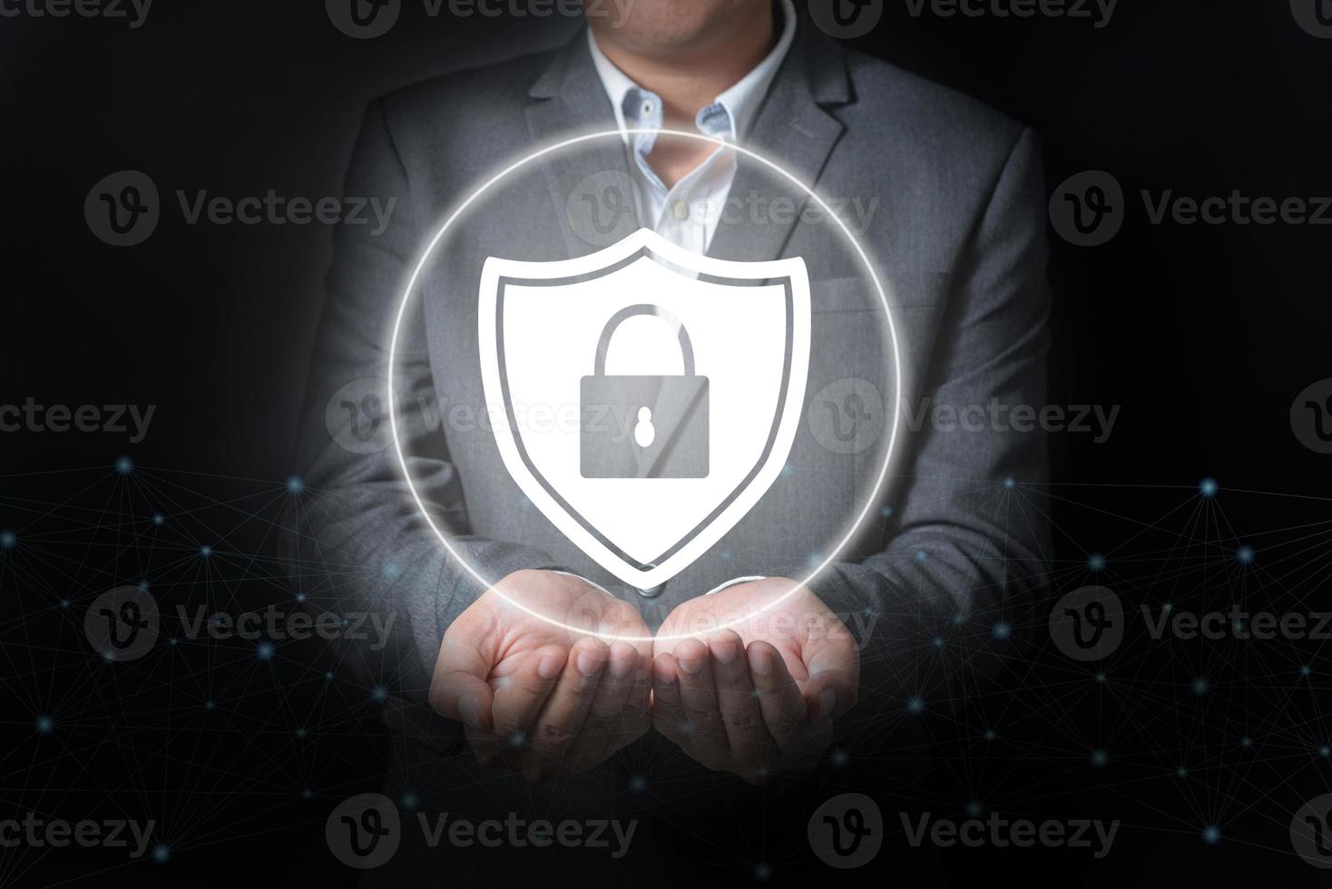 Double exposure of close up businessman holding security with key icon on balck and gray background photo