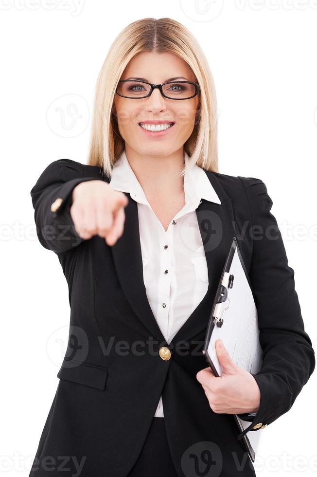 I choose you Cheerful mature businesswoman pointing you and smiling while standing isolated on white photo