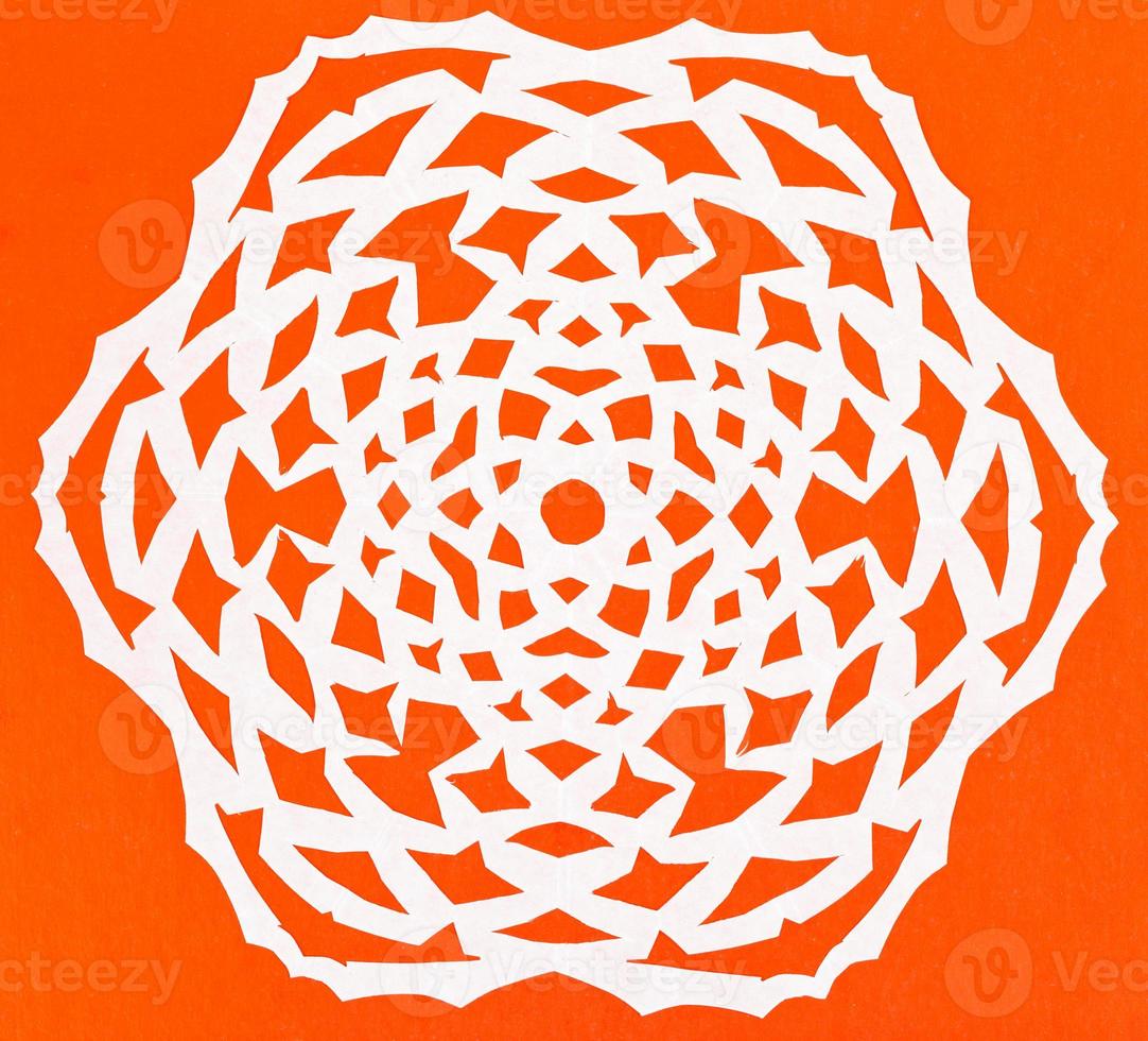 white snowflake on orange paper photo