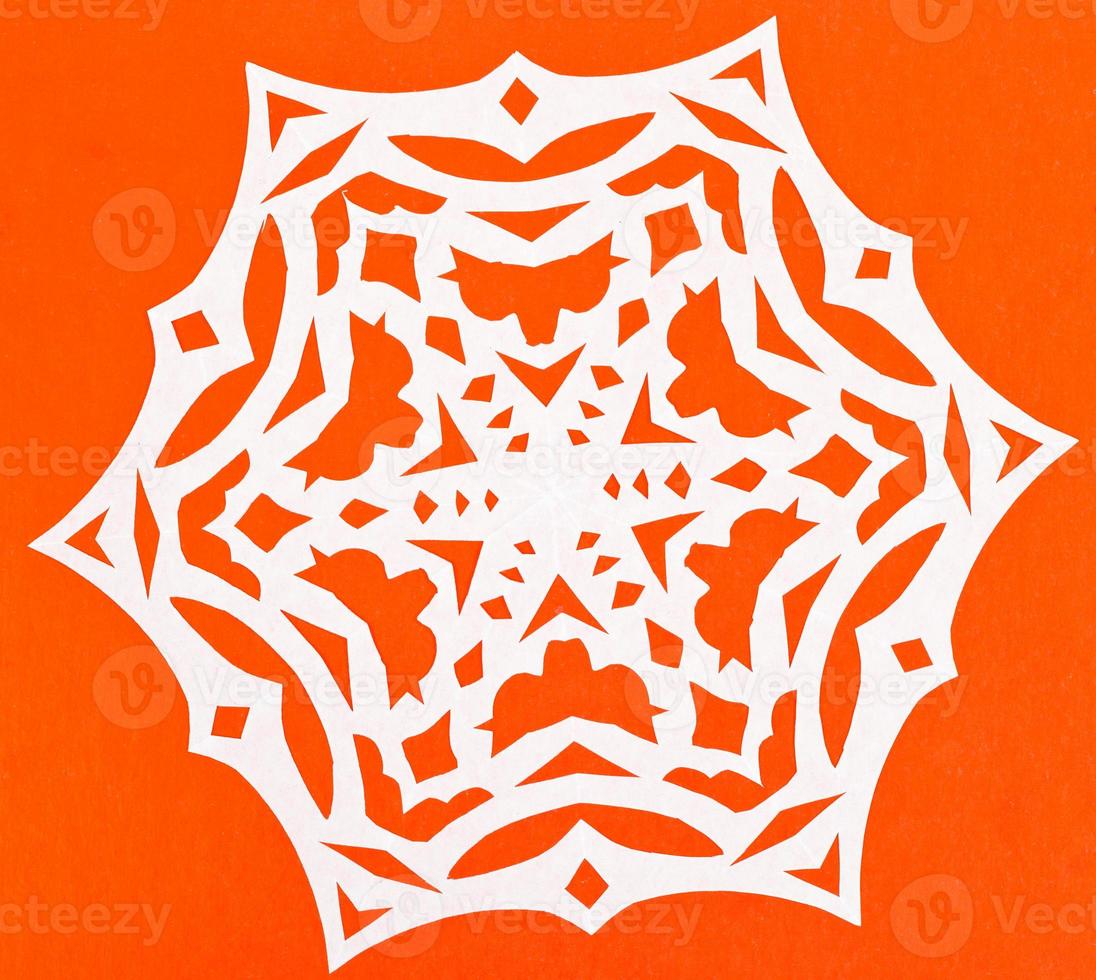 white snowflake on orange paper photo