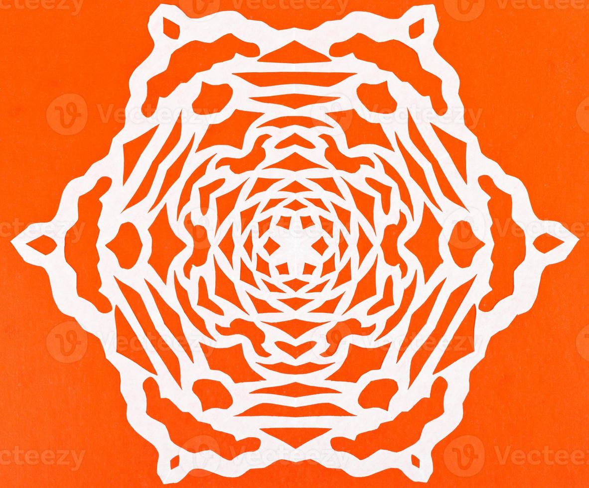 white snowflake on orange paper photo