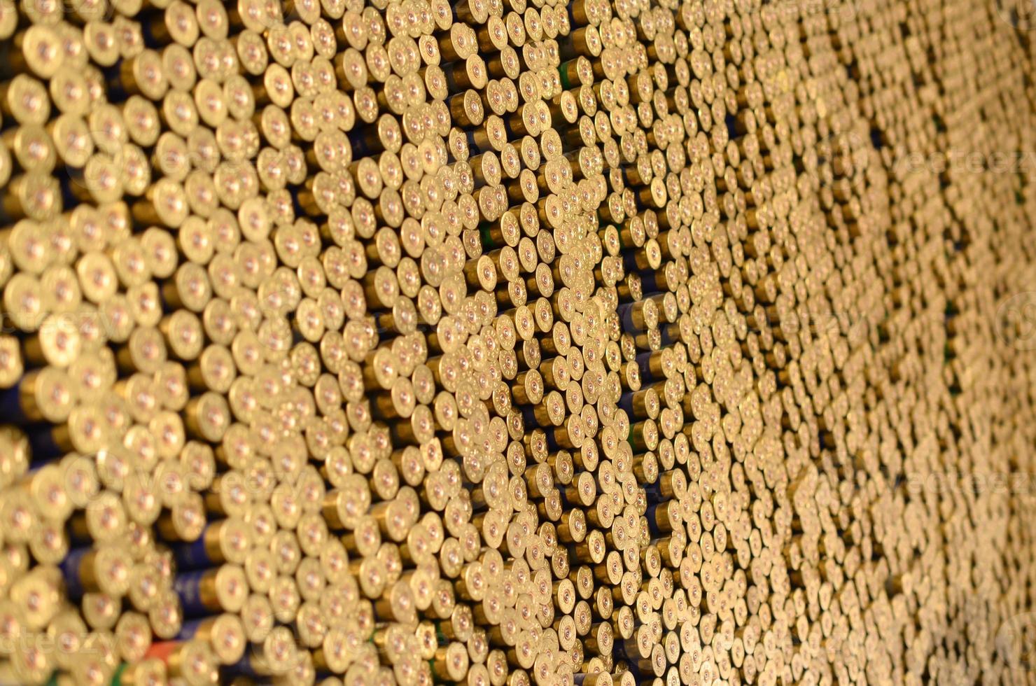 Pattern of 12 gauge cartridges for shotgun bullets. Shells for hunting rifle close up. Backdrop for shooting range or ammunition trade concepts photo