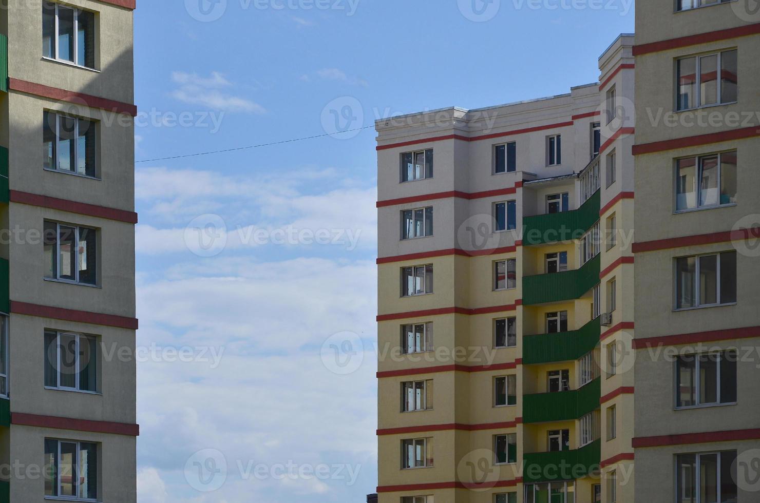 New or recently completed multi-storey residential building with windows and balconies. Russian type of house building photo