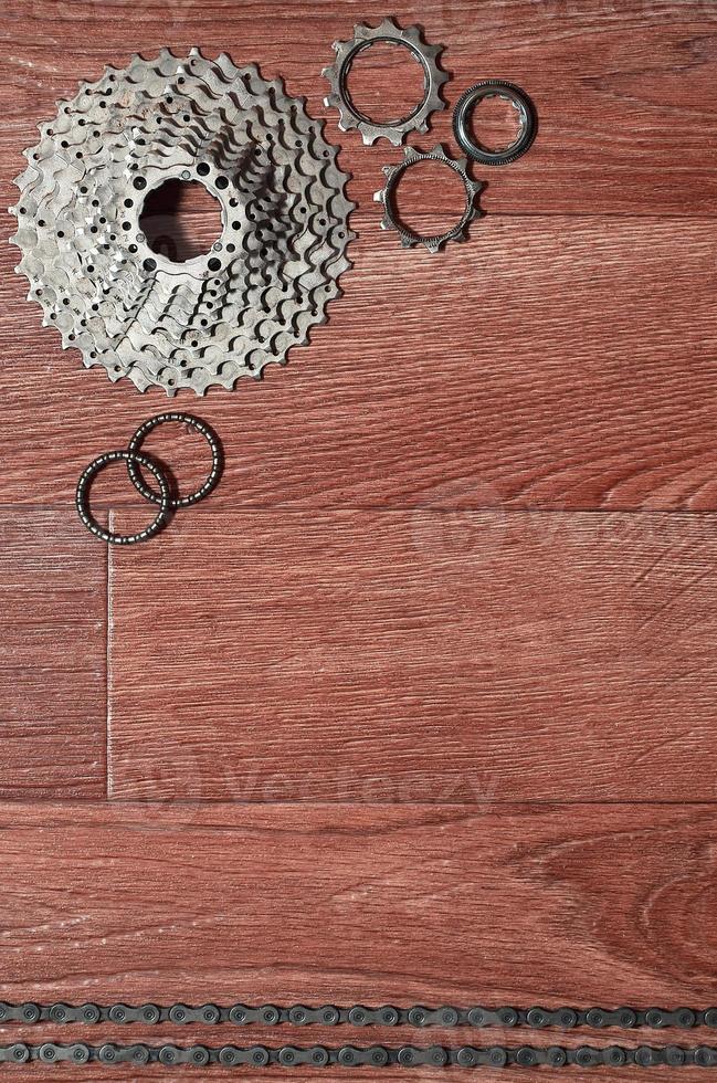 Some composition of a bicycle chain, several sprockets and other components of a sports bike photo