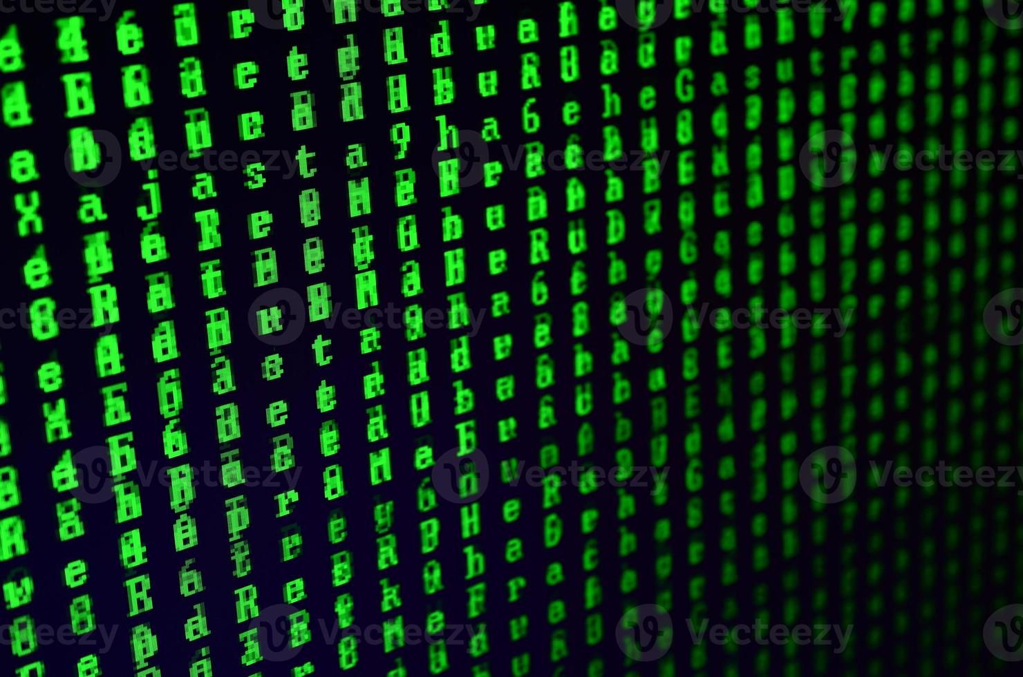 Macro shot of a glitch on the monitor of an office computer. The concept of introducing a virus into a personal data keeper. Stream of random green symbols on a black background photo