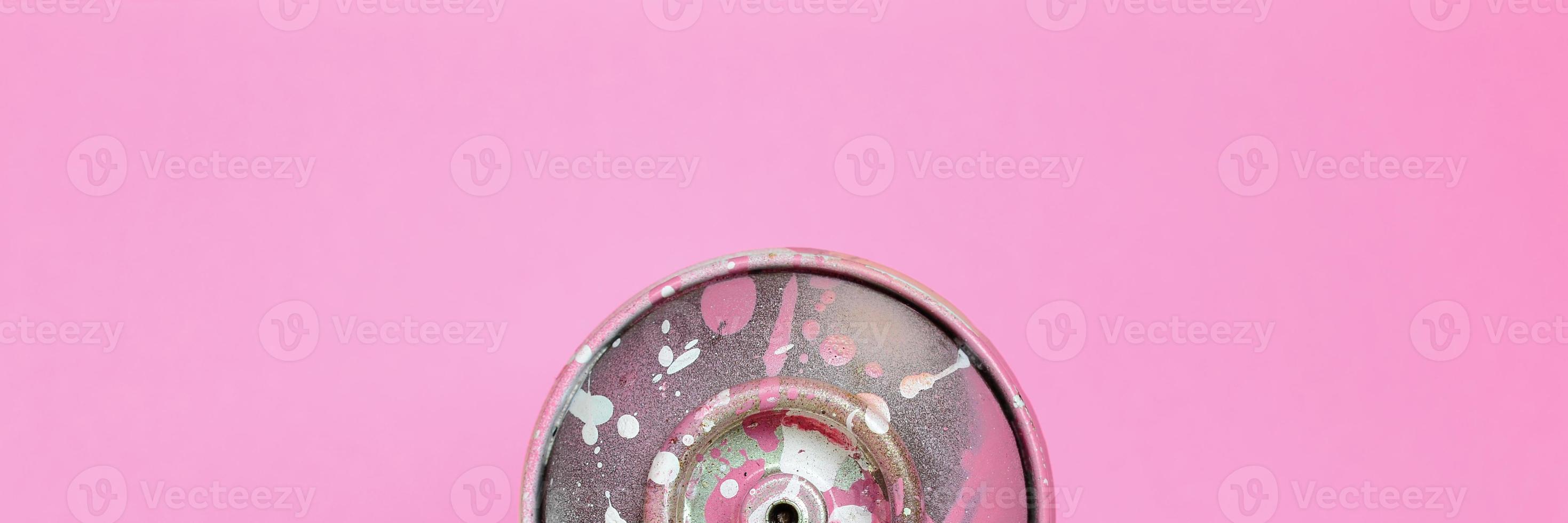 Used spray can with pink paint drips lie on texture background of fashion pastel pink color paper in minimal concept photo