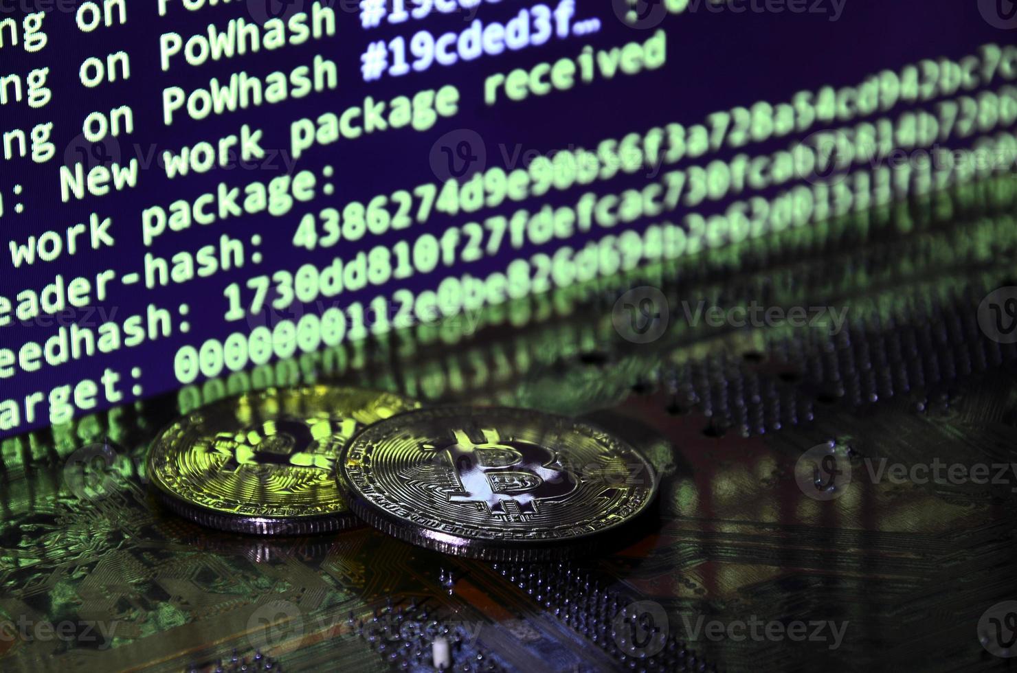 The digital process of cryptocurrency mining by using the GPUs. Bitcoins and video card on a working display and mining screen photo