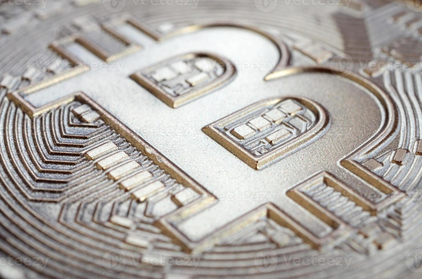 Close up shot of a physical bitcoin with a shiny relief surface made of chocolate. Abstract image of the crypto currency in an edible form photo