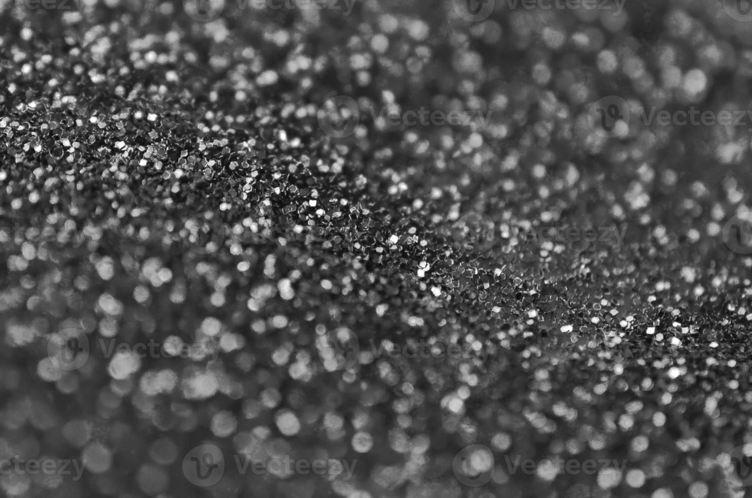 Silver decorative sequins. Background image with shiny bokeh lights from small elements photo