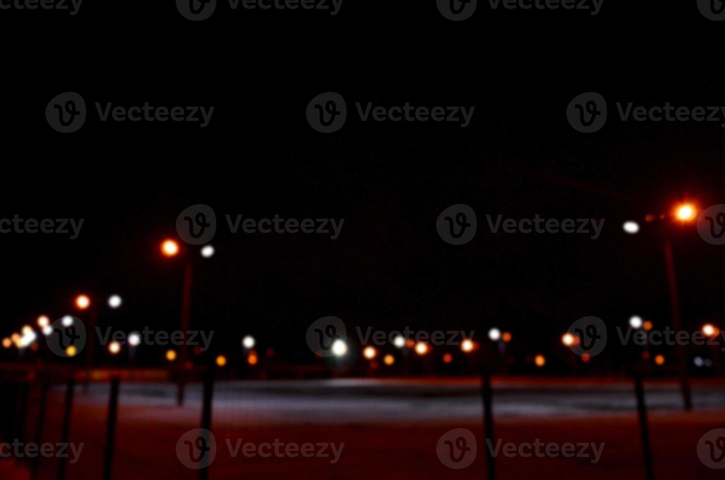 Blurred photo of school playground at night with bright lights