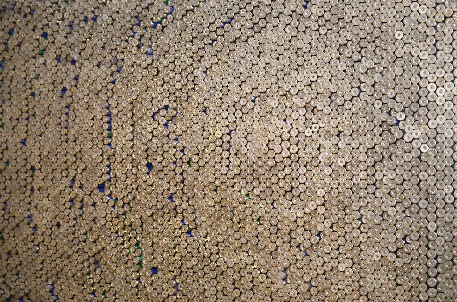 Pattern of 12 gauge cartridges for shotgun bullets. Shells for hunting rifle close up. Backdrop for shooting range or ammunition trade concepts photo