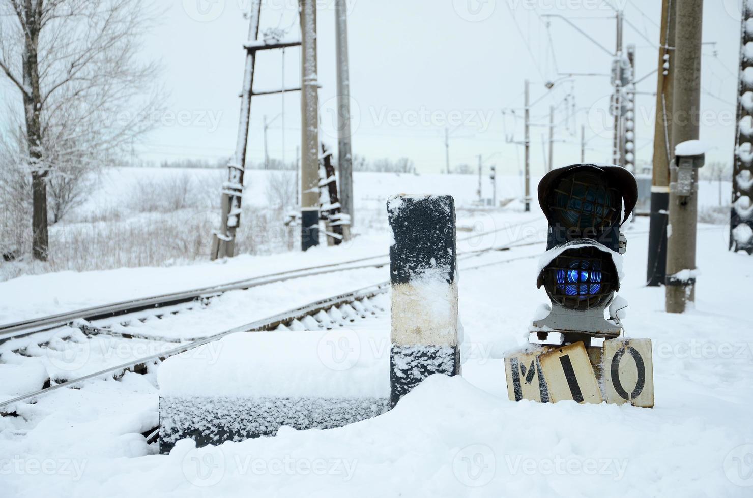 Semaphore is located on the motorway crossing the railway line in winter season photo