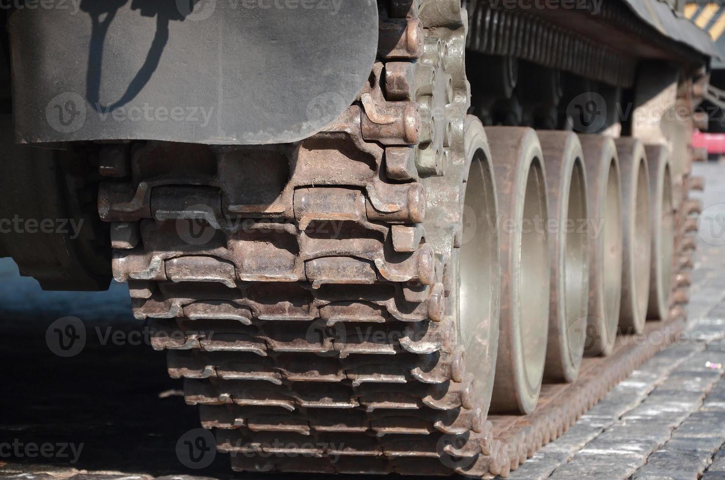 Close up of green armoured caterpillar transport. Modern military transportation vehicle technologies photo