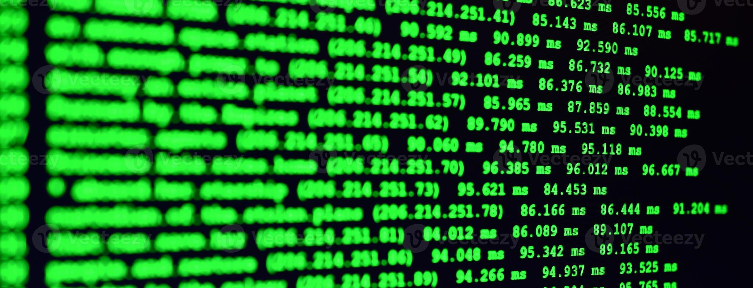 Macro shot of the command line on the monitor of the office computer. The concept of the programmer's work. Information line flow photo