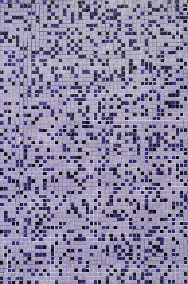 The texture of the wall, decorated with a mosaic of various small square tiles. Abstract pattern of ceramic tiles on the wall photo