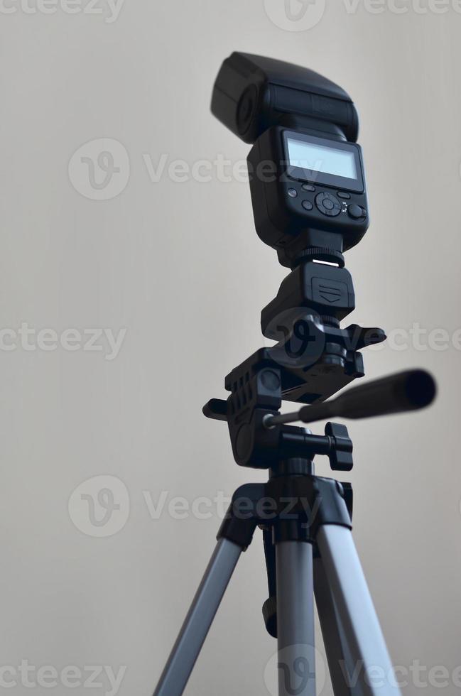 Speedlight gun with trigger set mounted on tripod photo