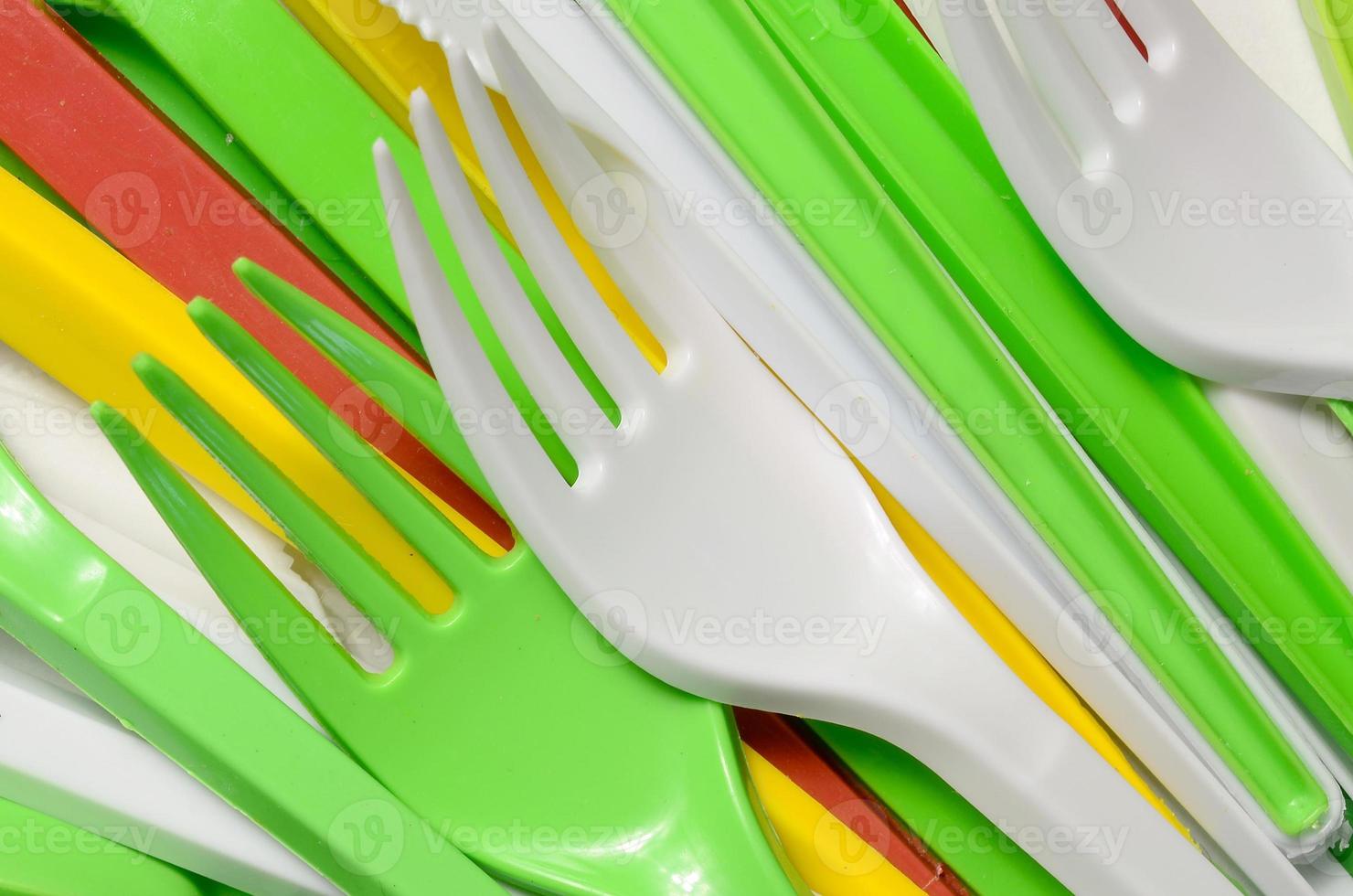 Pile of bright yellow, green and white used plastic kitchenware