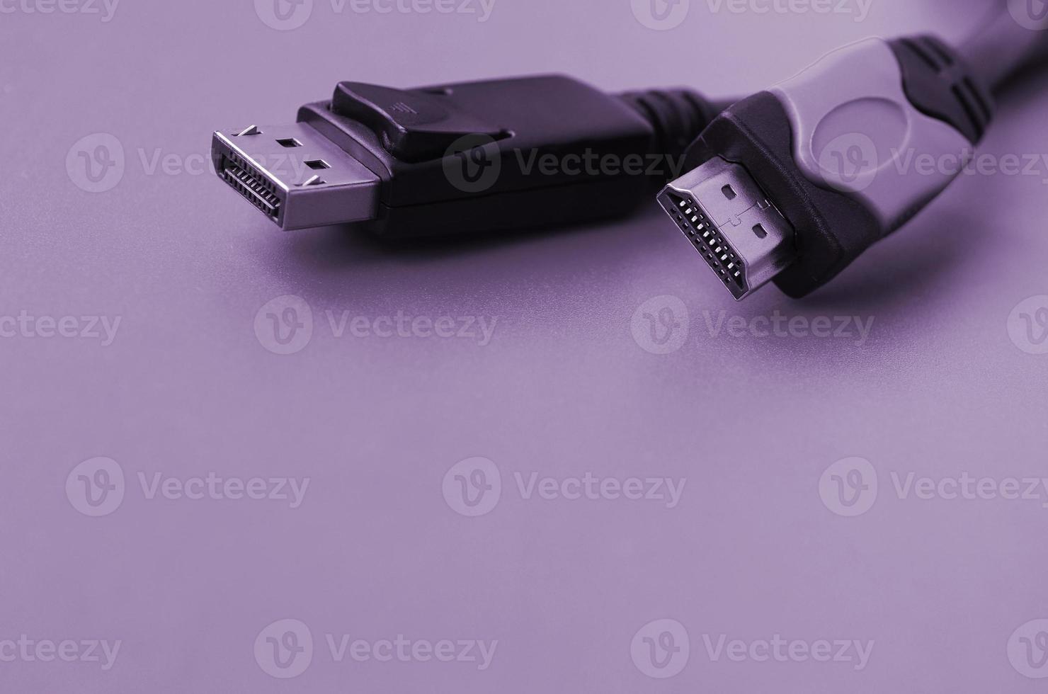 Audio video HDMI computer cable plug and 20-pin male DisplayPort gold plated connector for a flawless connection on purple backdrop photo