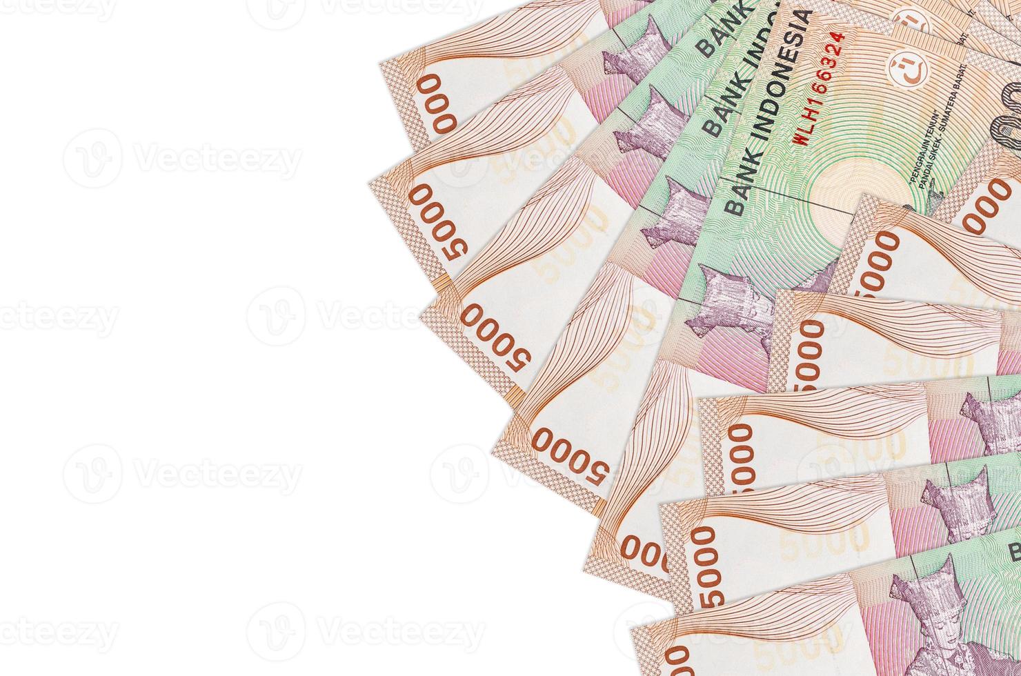 5000 Indonesian rupiah bills lies isolated on white background with copy space. Rich life conceptual background photo