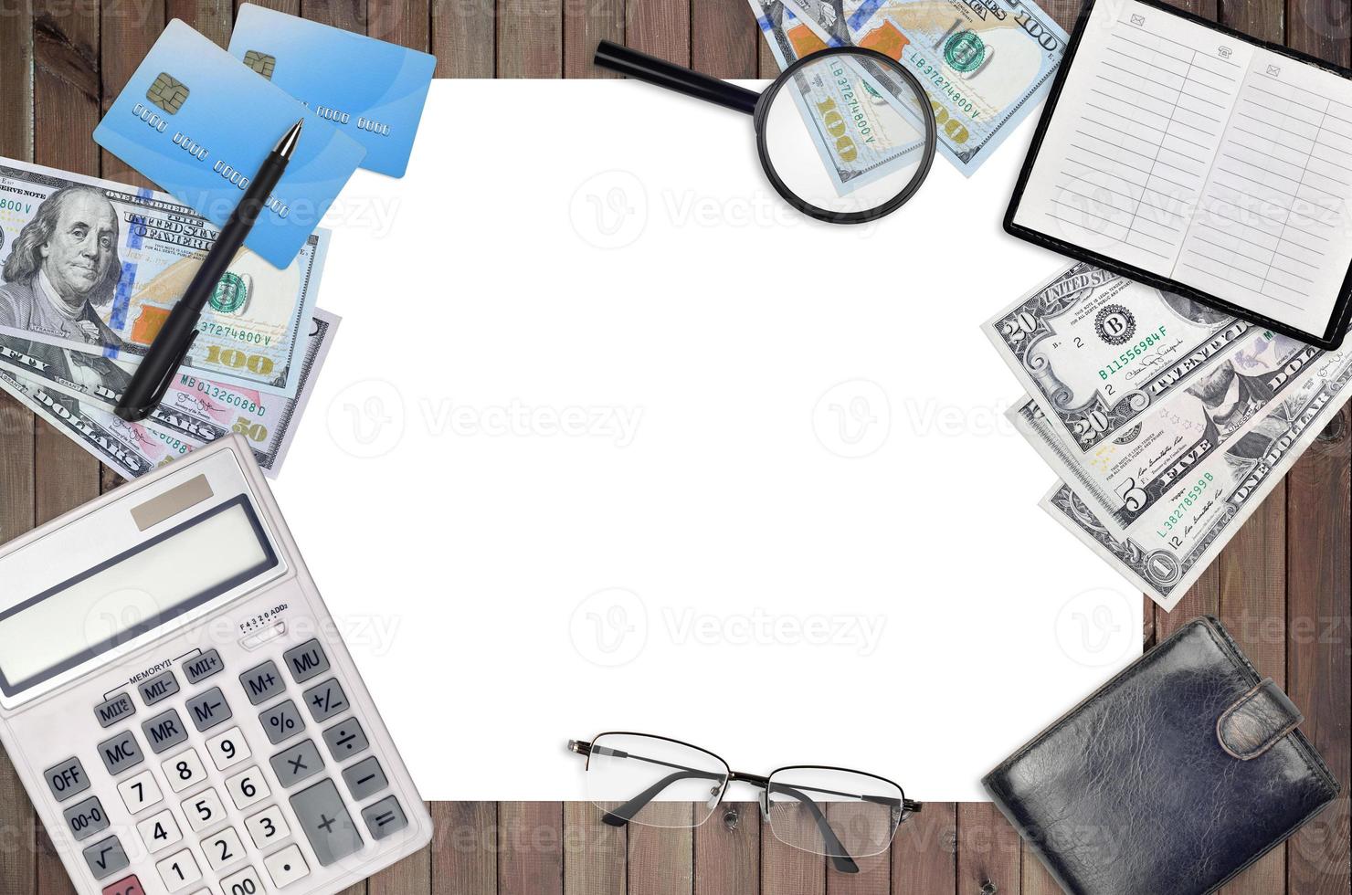 Office flat lay composition with calculator, address book and other office items on brown wooden table background with top view. Accountant paperwork photo