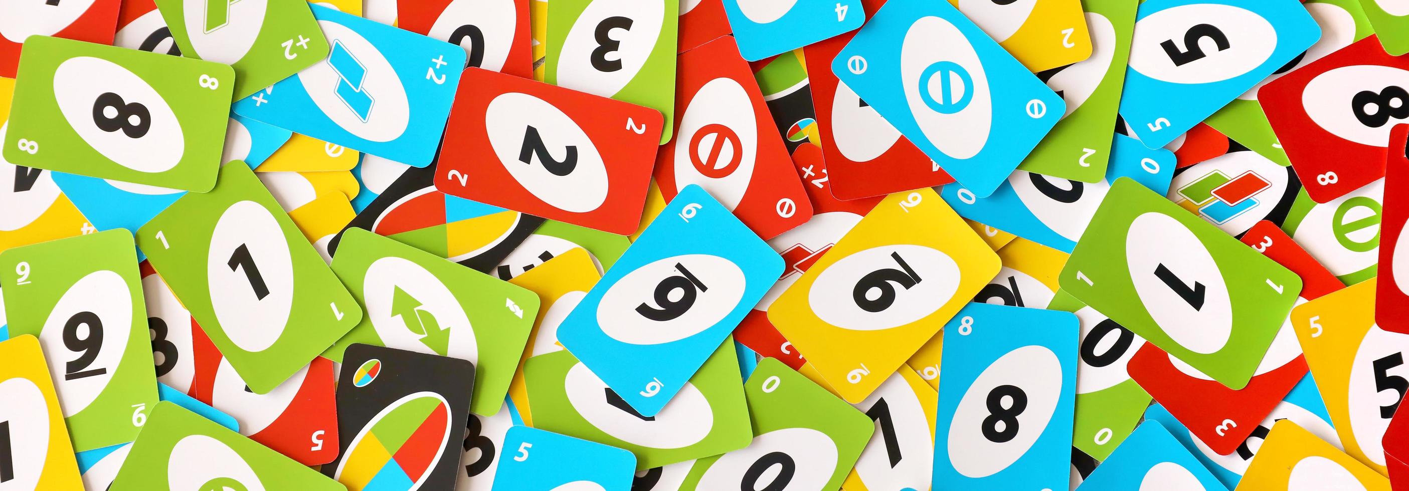 TERNOPIL, UKRAINE - MAY 15, 2022 Many colorful UNO game cards. UNO is an American shedding-type card game that is played with a specially printed deck photo