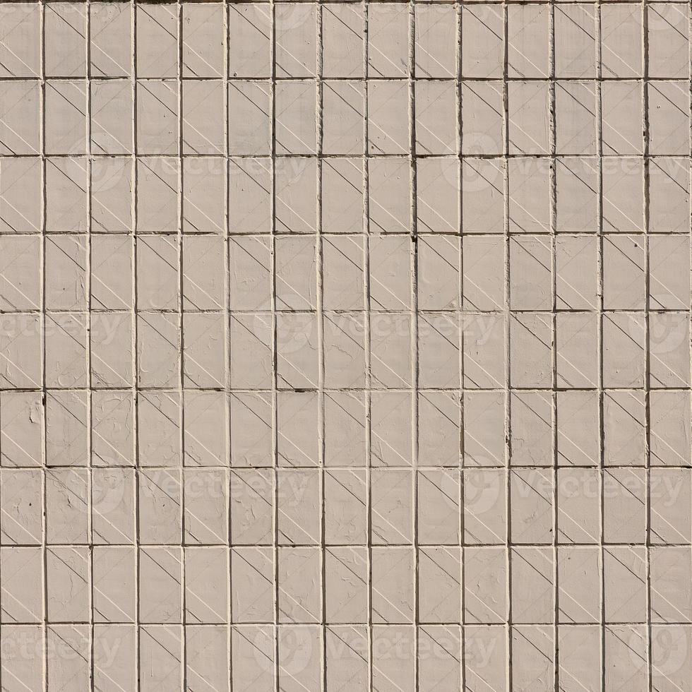 Old Soviet beige wall tiles. The texture of the classical outer tile, which was revetted by buildings during the times of the Soviet Union photo