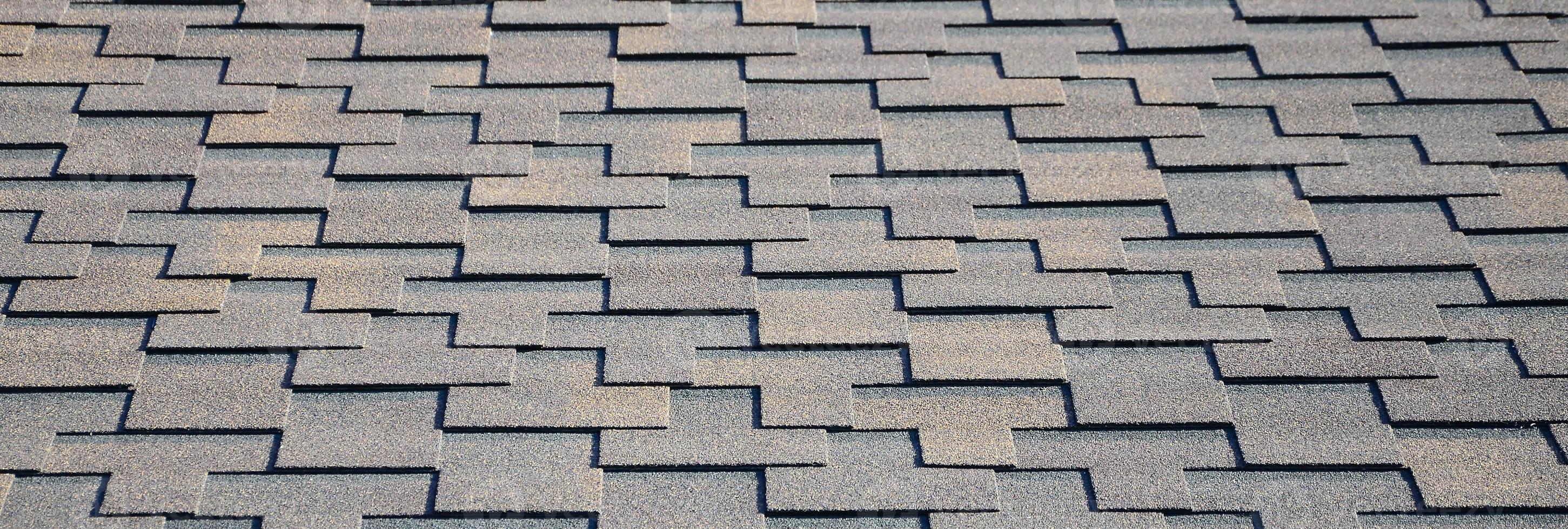 Modern roofing and decoration of chimneys. Flexible bitumen or slate shingles photo