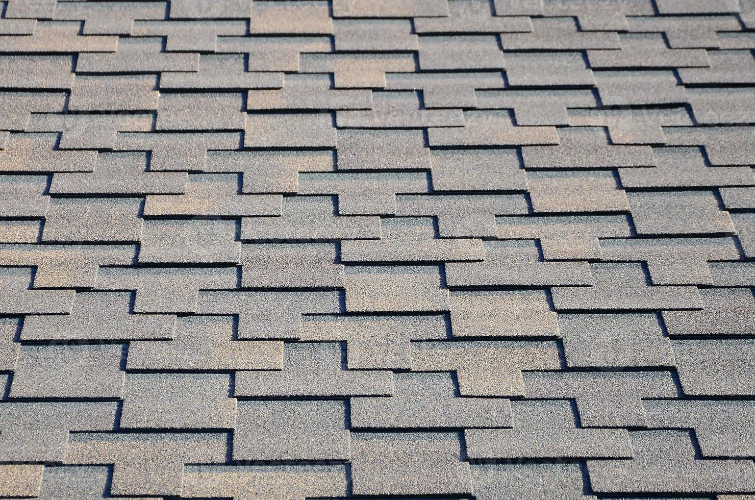 Modern roofing and decoration of chimneys. Flexible bitumen or slate shingles photo