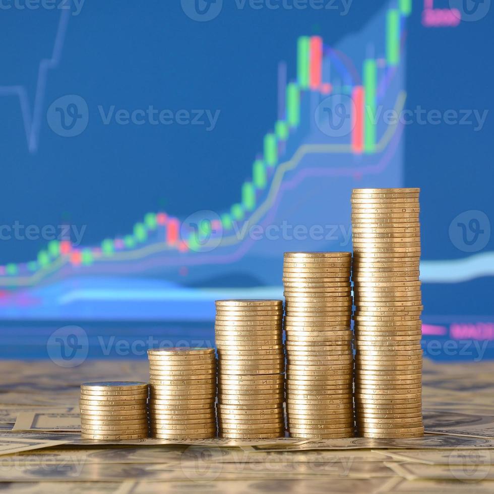 Golden coin stacks arranged as a graph. Increasing columns of coins photo