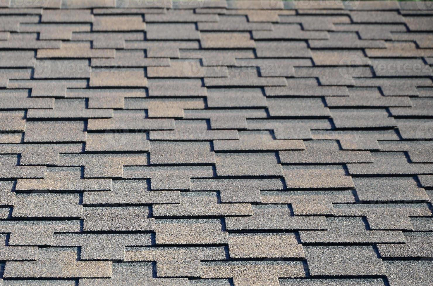 Modern roofing and decoration of chimneys. Flexible bitumen or slate shingles photo