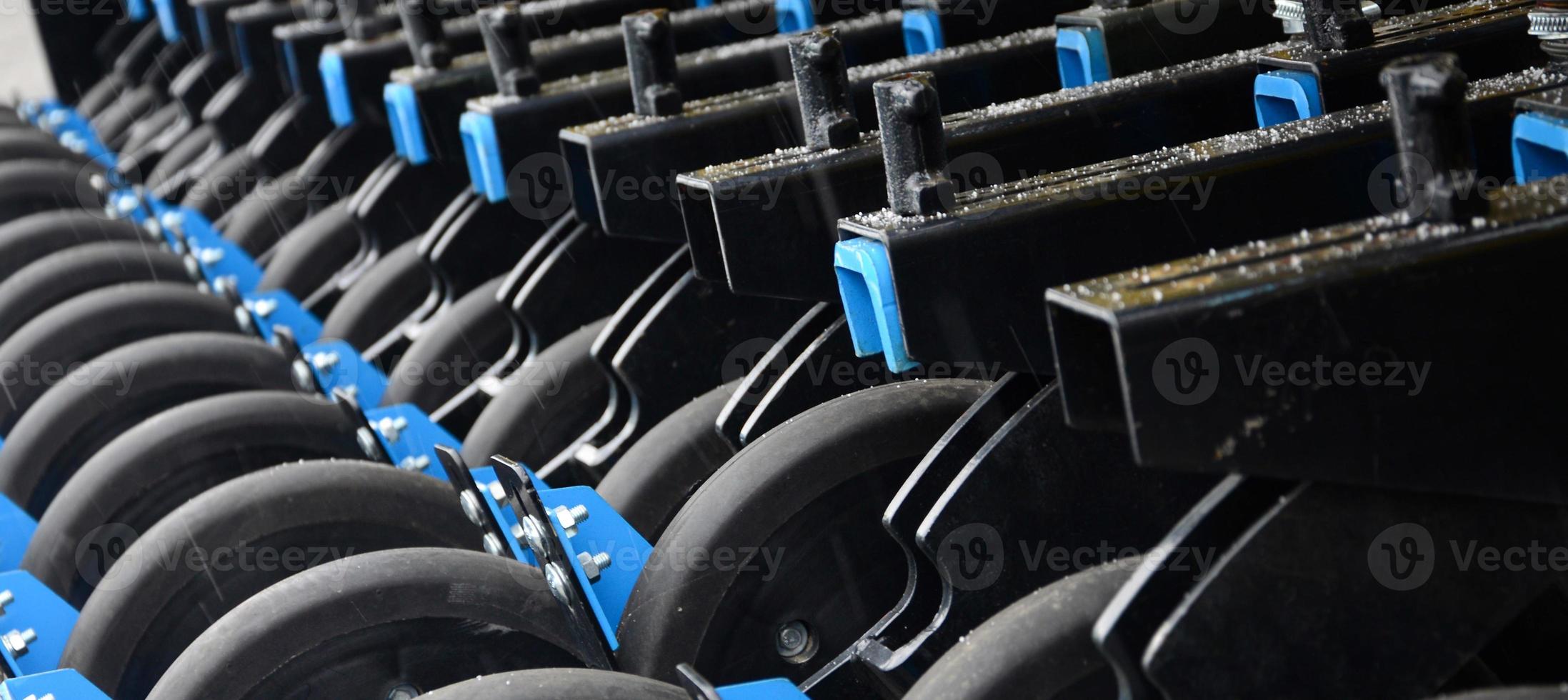 Row of wheels of the new industrial agricultural seeder close up photo