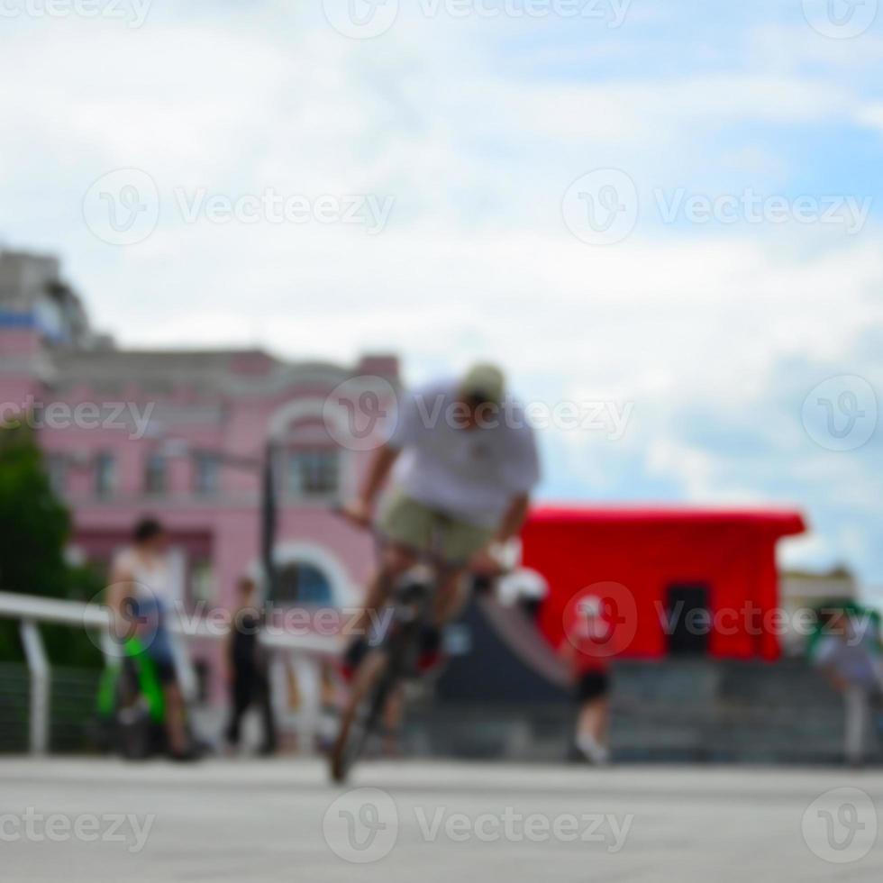 Defocused image of a lot of people with bmx bikes. Meeting of fans of extreme sports photo