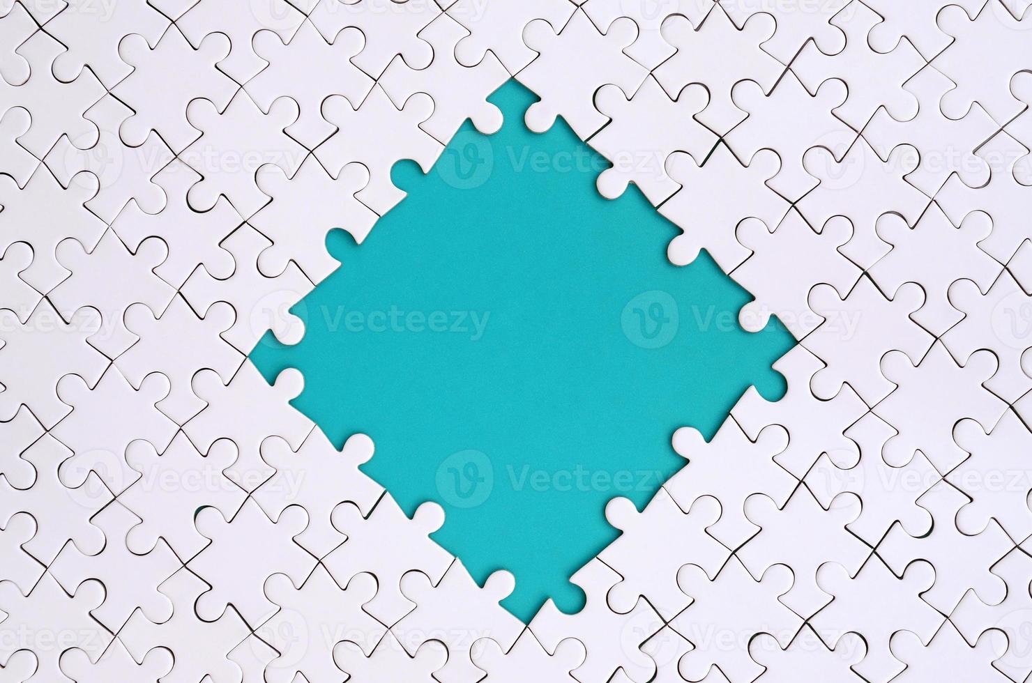 Framing in the form of a rhombus, made of a white jigsaw puzzle around the blue space photo