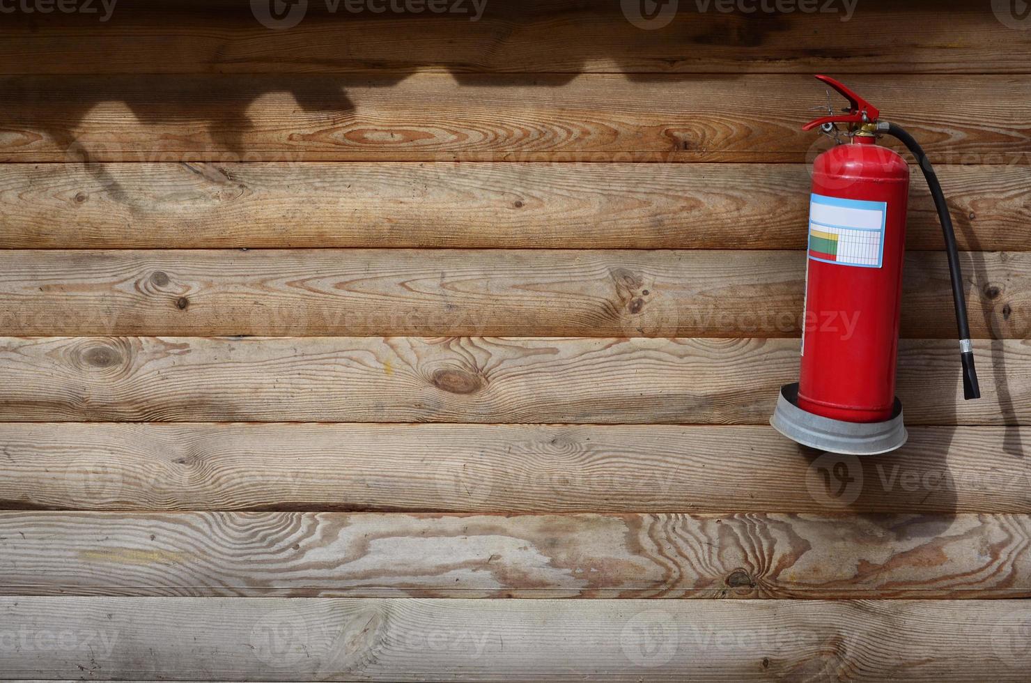 The texture of wooden wall with red extinguisher photo