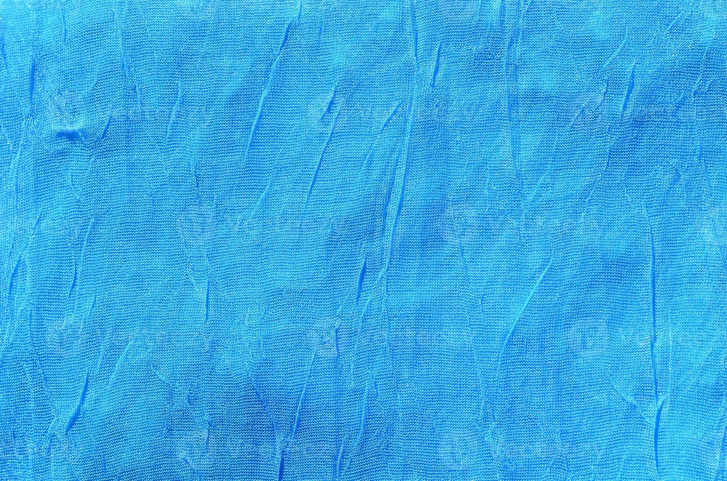 Creased blue cloth material fragment as a background texture 13605779