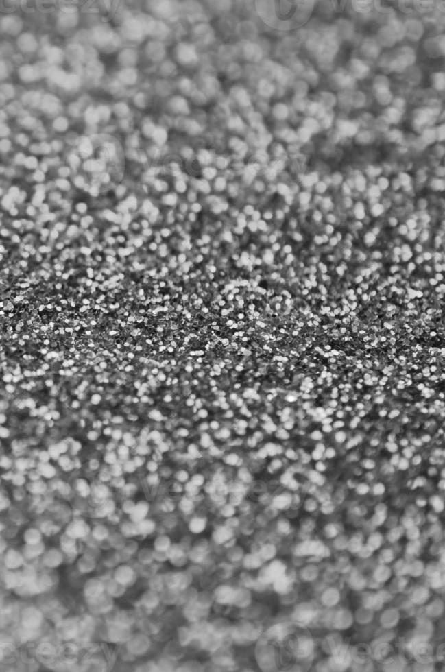 Silver decorative sequins. Background image with shiny bokeh lights from small elements photo