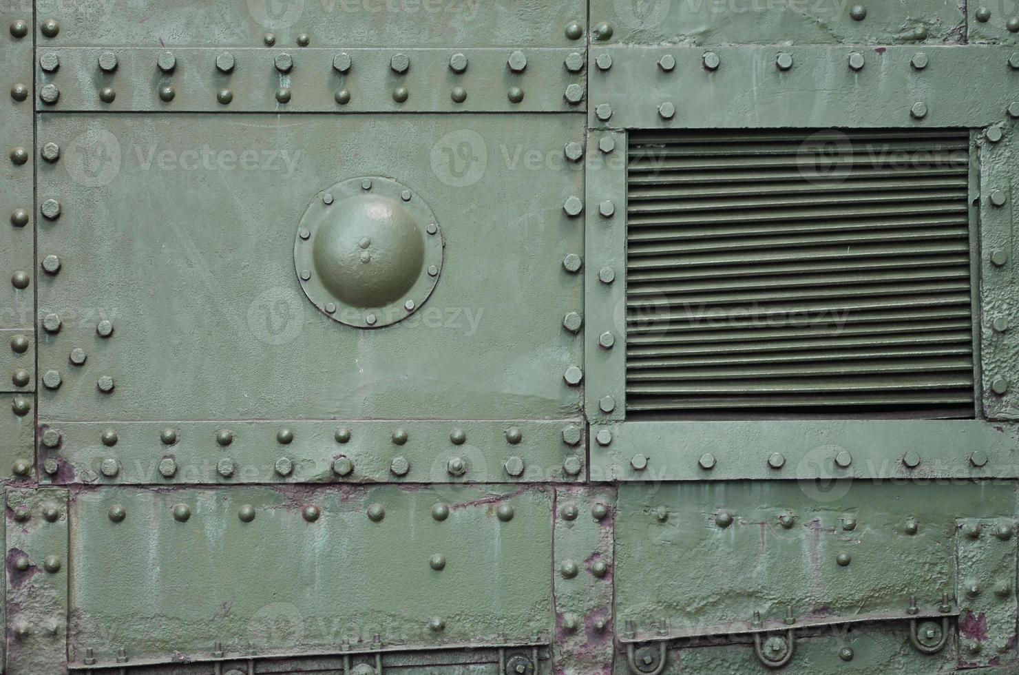 The texture of the wall of the tank, made of metal and reinforced with a multitude of bolts and rivets. Images of the covering of a combat vehicle from the Second World War photo