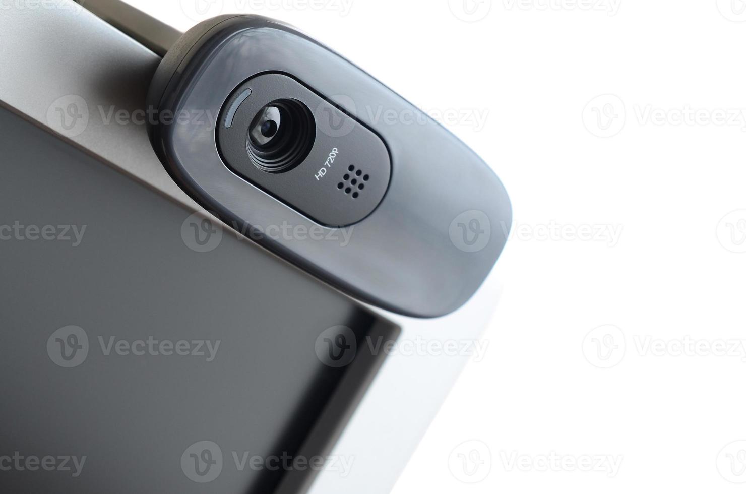 A modern web camera is installed on the body of a flat screen monitor. Device for video communication and recording of high quality video photo