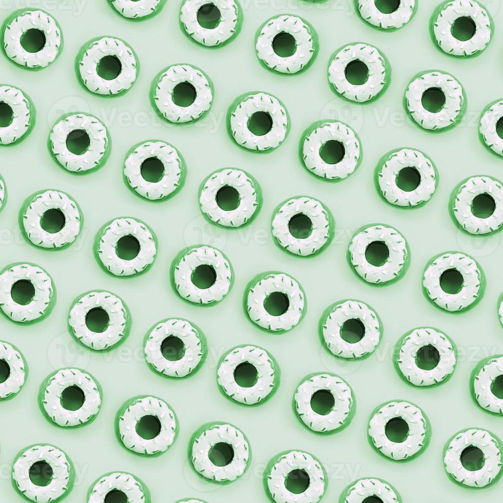Many small plastic donuts lies on a pastel colorful background. Flat lay minimal pattern. Top view photo