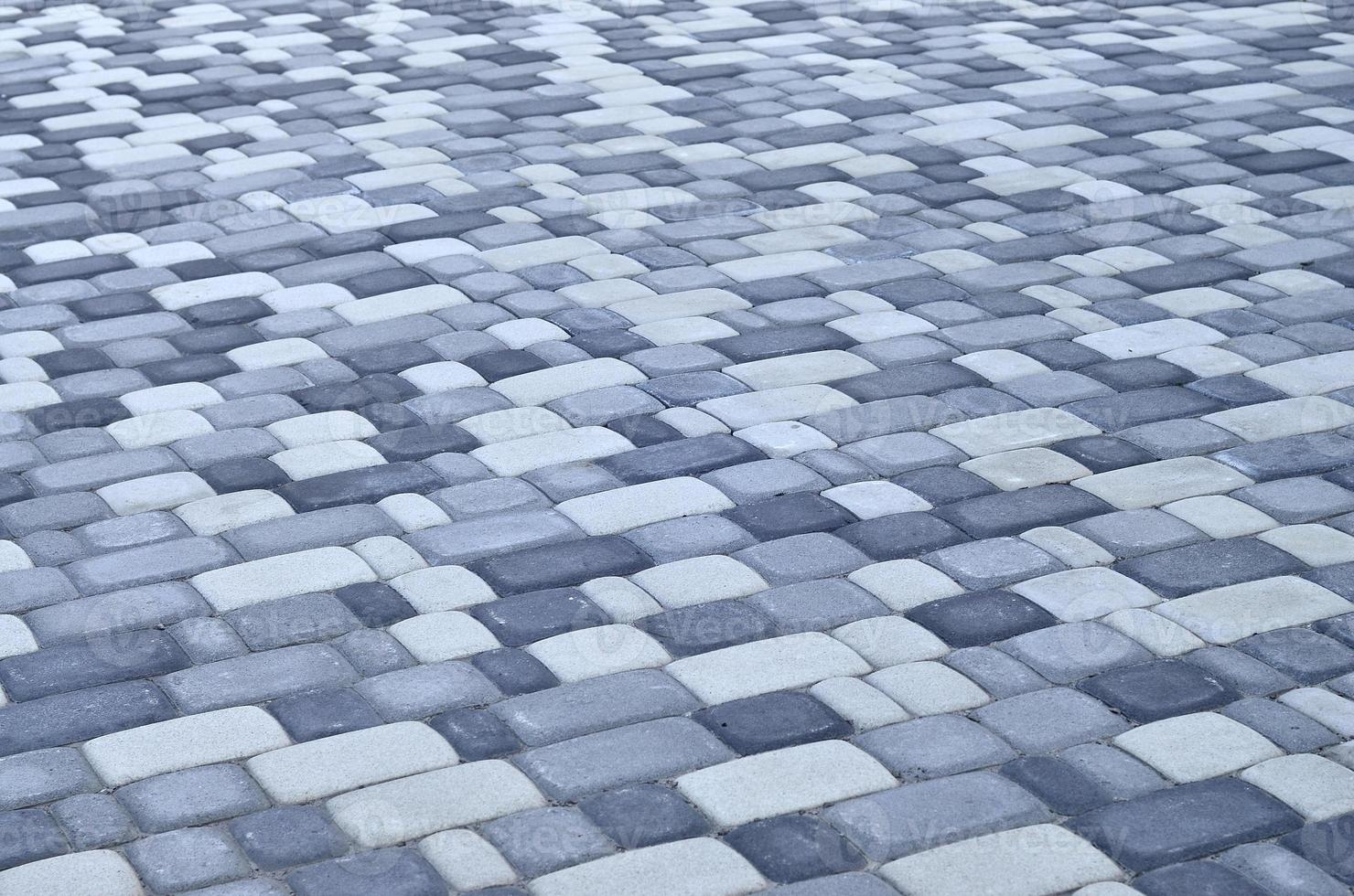 A detailed photo of the square, laid out of modern paving stone with rounded corners. Accurate design of pedestrian areas