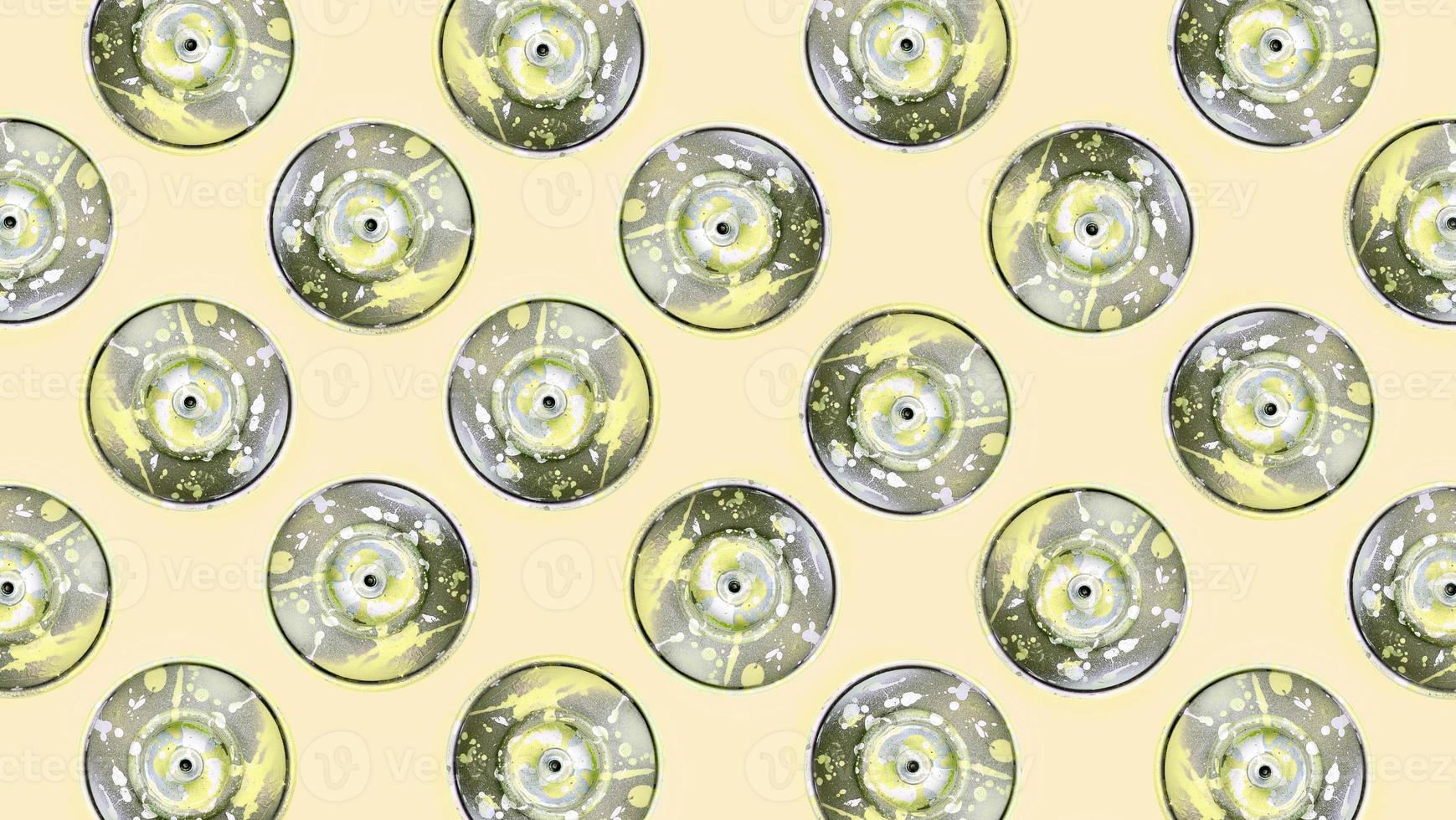 Many used spray cans for graffiti drawing lies on a pastel colored backgroung. Street art painting concept. Minimal flat lay pattern. Top view photo