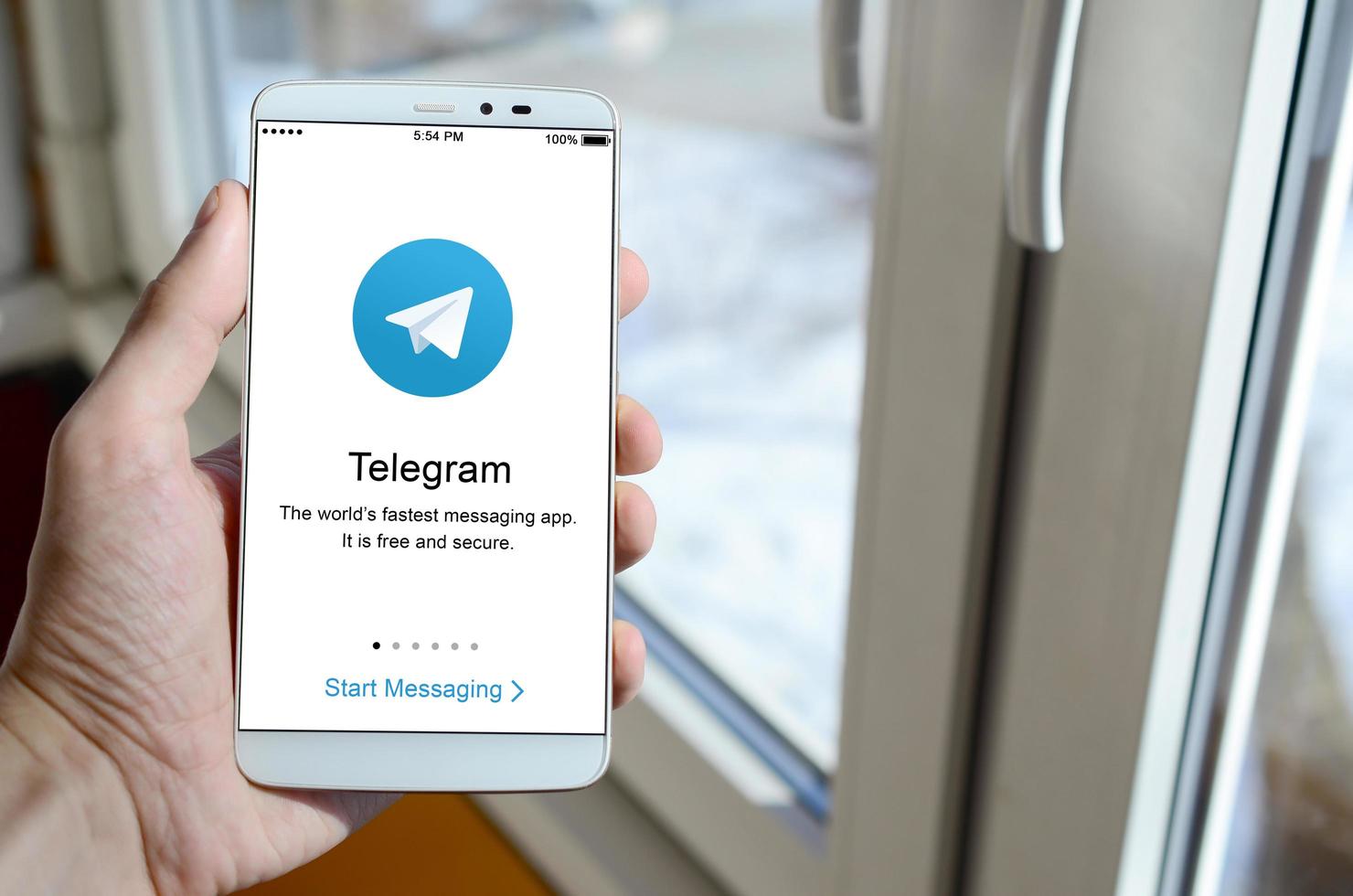 KHARKOV, UKRAINE - APRIL 27, 2018 A mobile phone with the Telegram app screen in hand photo