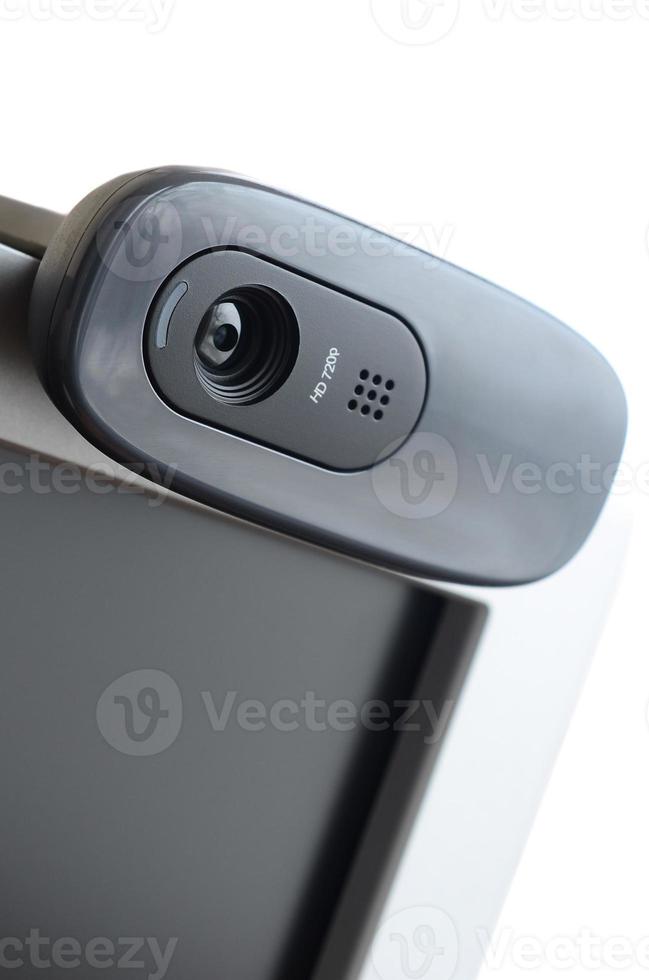 A modern web camera is installed on the body of a flat screen monitor. Device for video communication and recording of high quality video photo