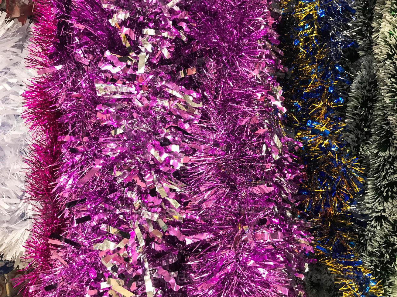 Festive multicolored rainbow shiny silver beautiful Christmas plastic garland sparkling for the New Year, Christmas-tree tinsel, festively decorated. Texture. Background photo